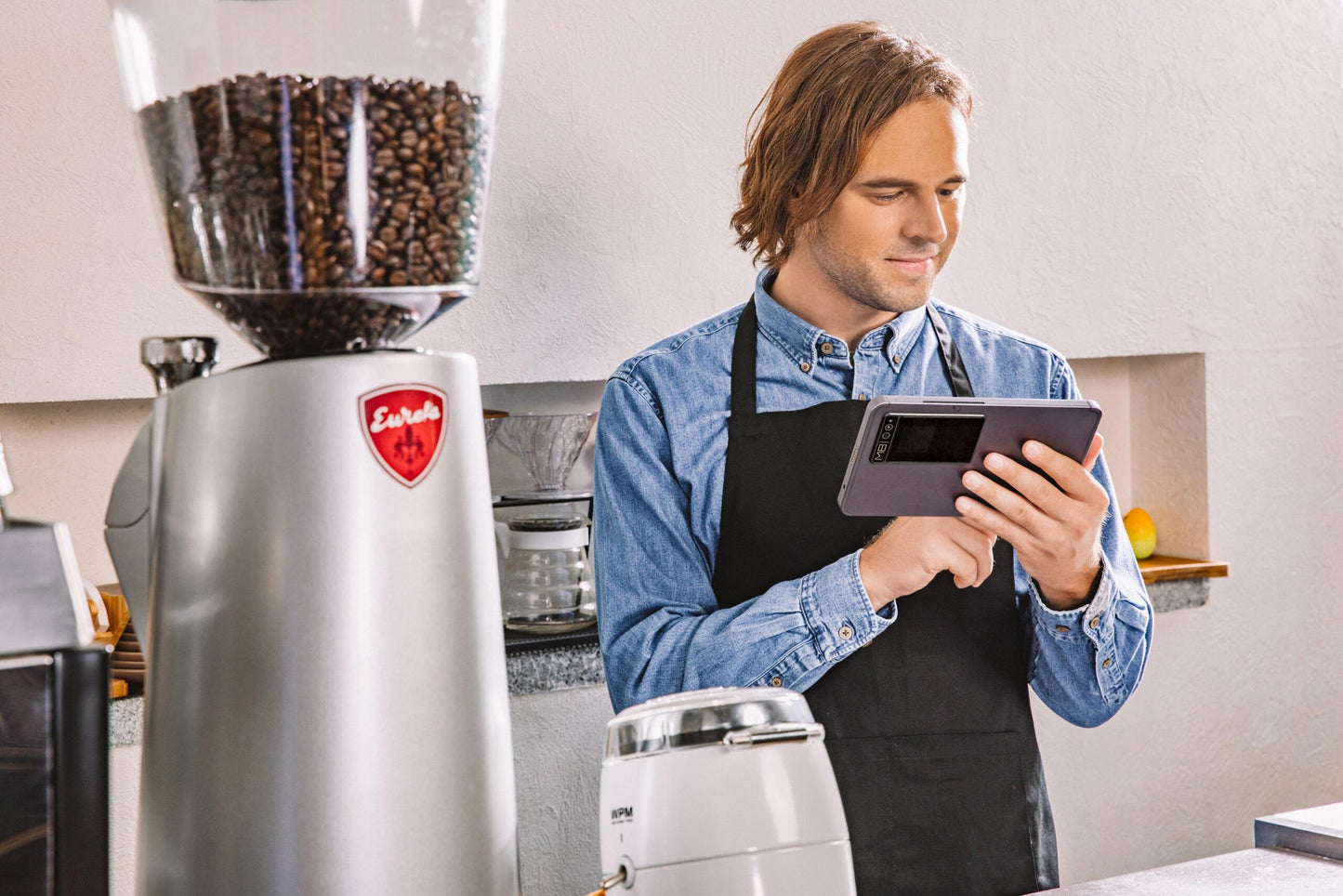 Person using mobile payment device in coffee shop