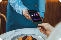 PAX A6630 taking a tableside contactless payment in a restaurant