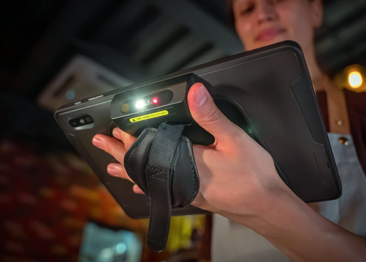Person holding SUNMI M2 MAX enterprise tablet with barcode scanner and LED lights for business use