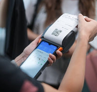 Customer using SUNMI V2s Plus mobile POS to scan QR code receipt
